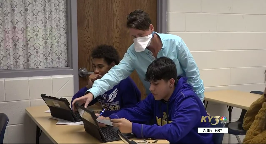 Ms. Sampson helps students in class.