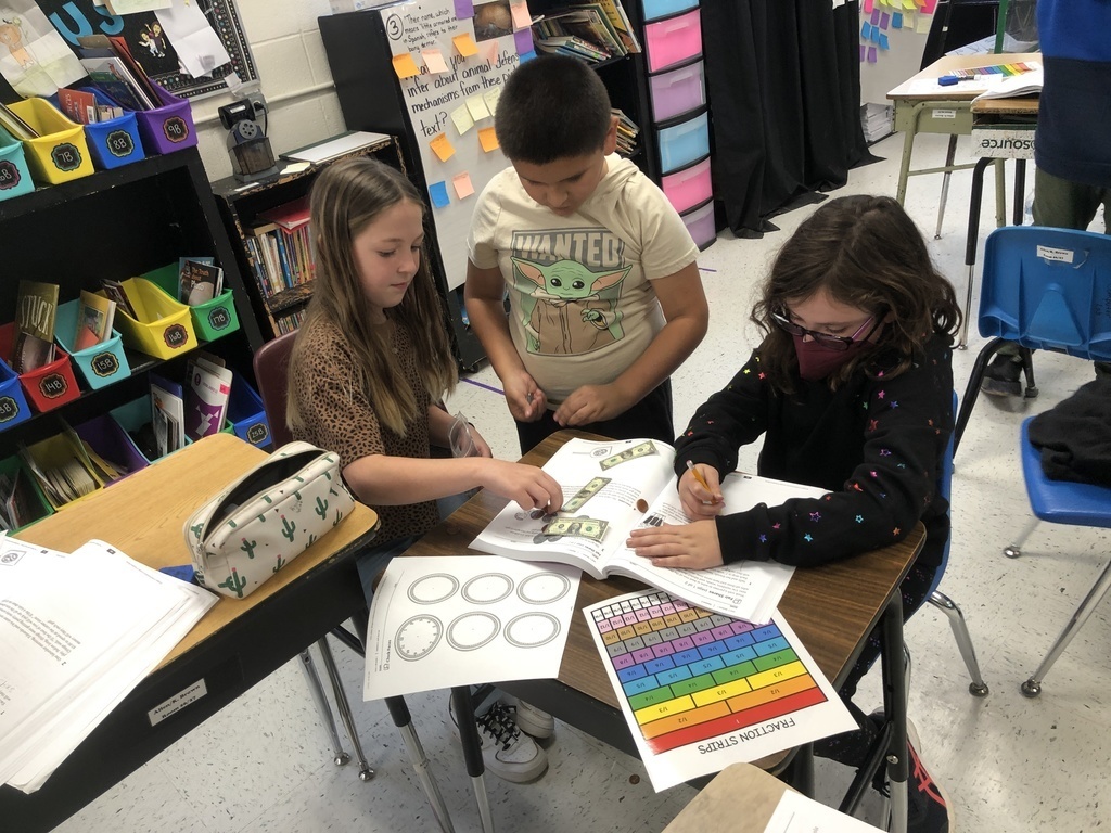 Mrs. Brown and Mrs. Allen's class learned how to use fraction strips, money pieces, and clocks to solve word problems in math. 