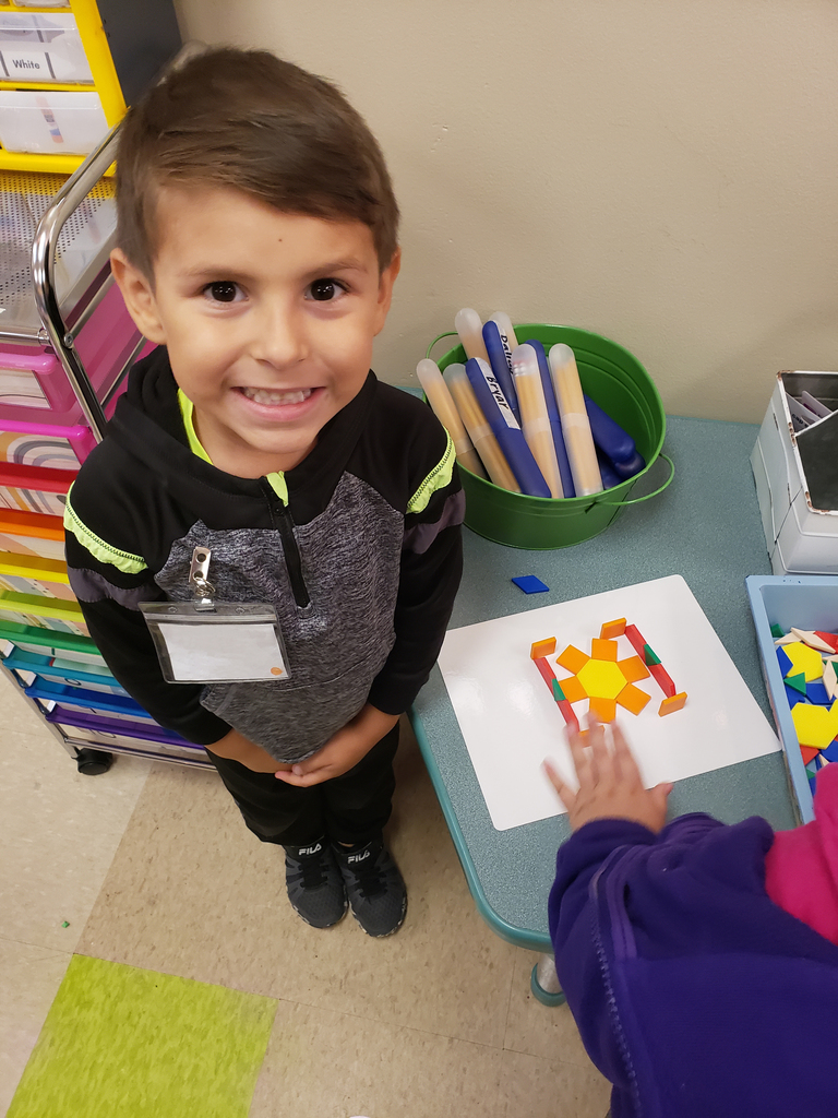 Student posing for a photo while working on math. 