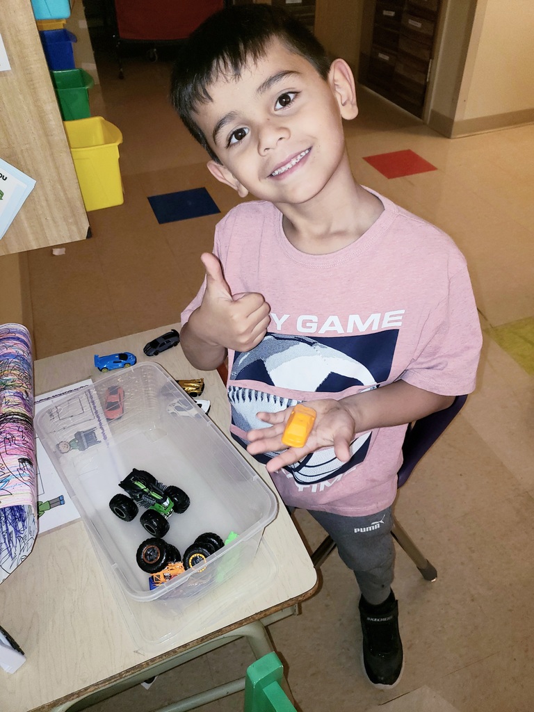 Student gives thumbs up while working on math. 