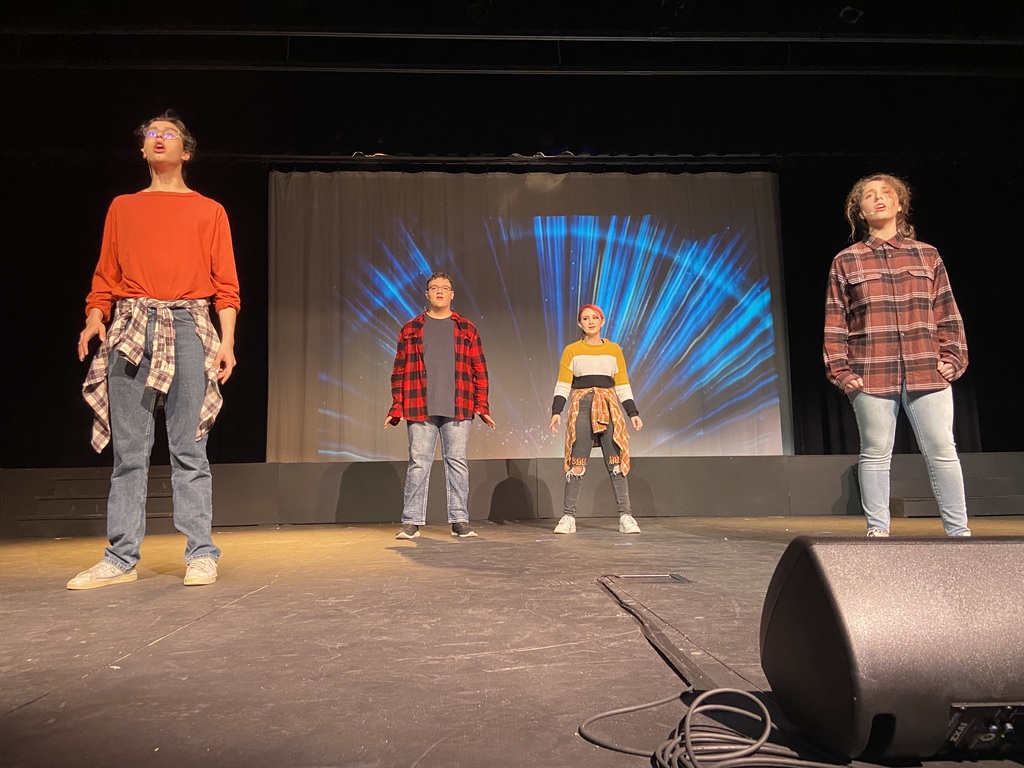 Theatre performance, four people in a row. 