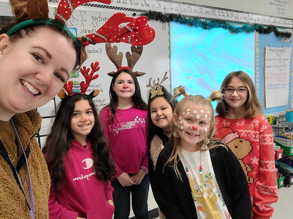Ms. Wiley's photo with students who wore their reindeer Christmas antlers. 