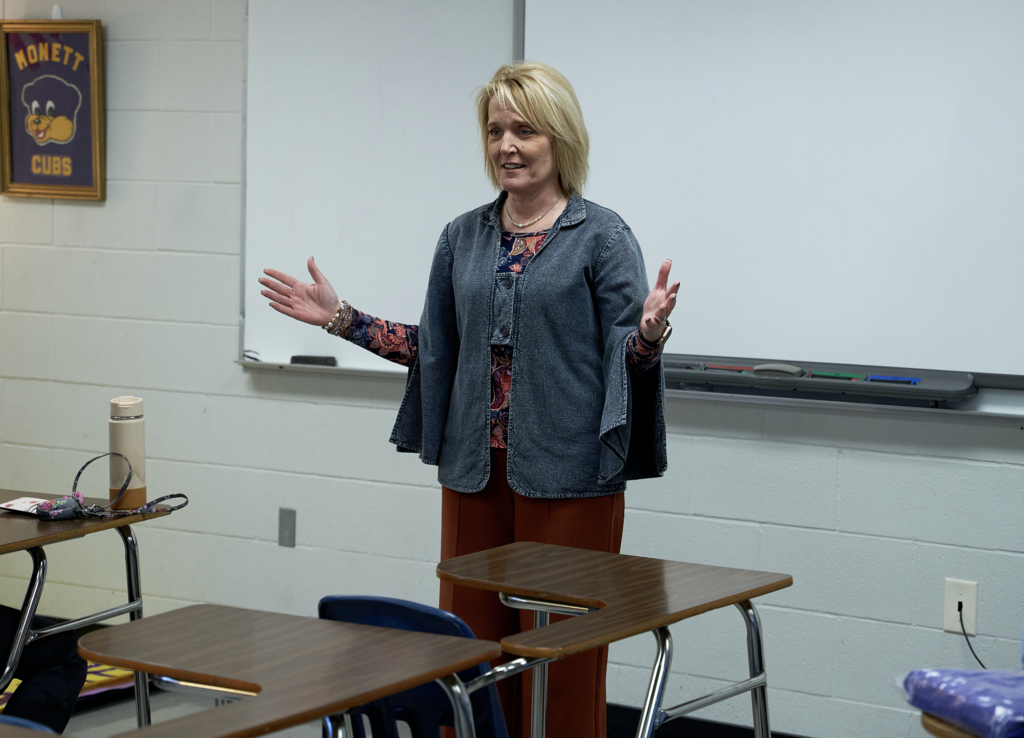 Margie Vandeven speaking in front of the class. 