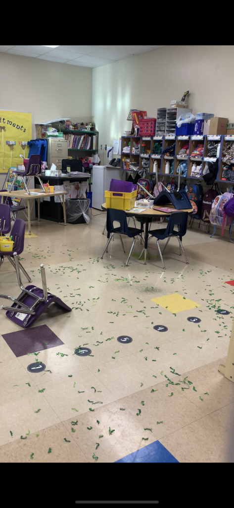 Classroom with green confetti on the floor left behind by leprechaun. 