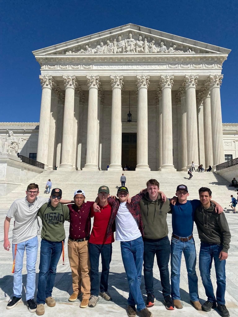 JROTC students standing in front of a building. 