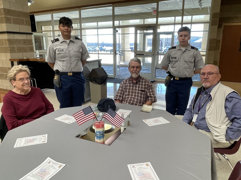6 people sitting at a table for Veterans Day