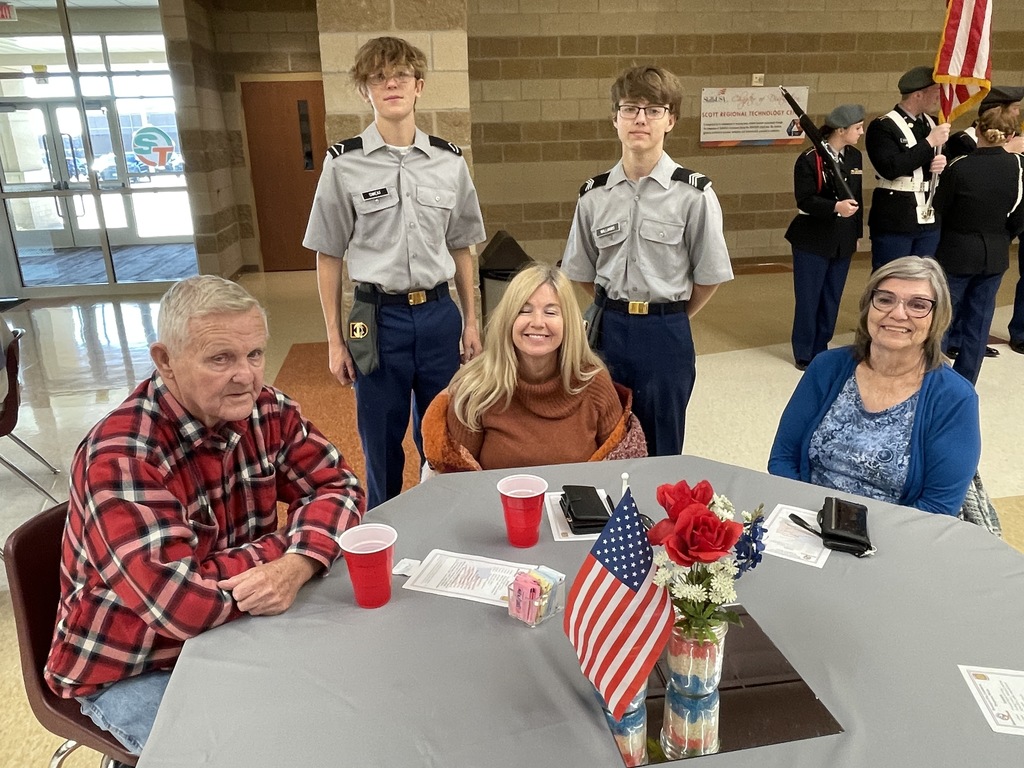 5 people sitting at a table for the Veterans Day Luncheon at Scott Regional Tech Center.