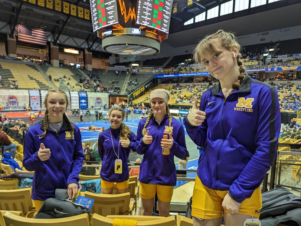 Wrestling girls team wearing purple and gold at the STATE wrestling chanpionship