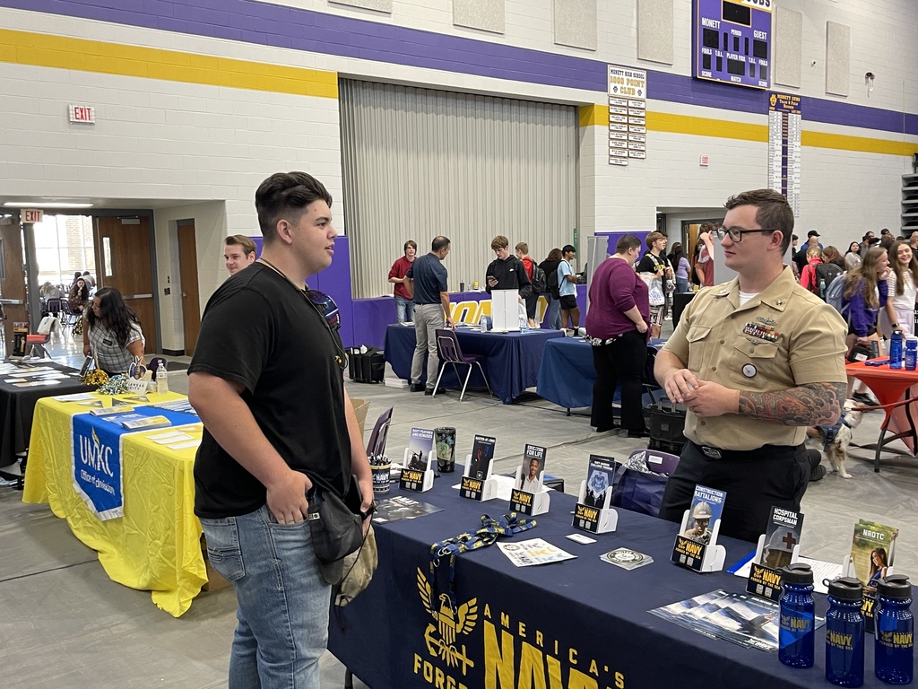 Student speaking to the navy recruiter during the College and Career Fair. 